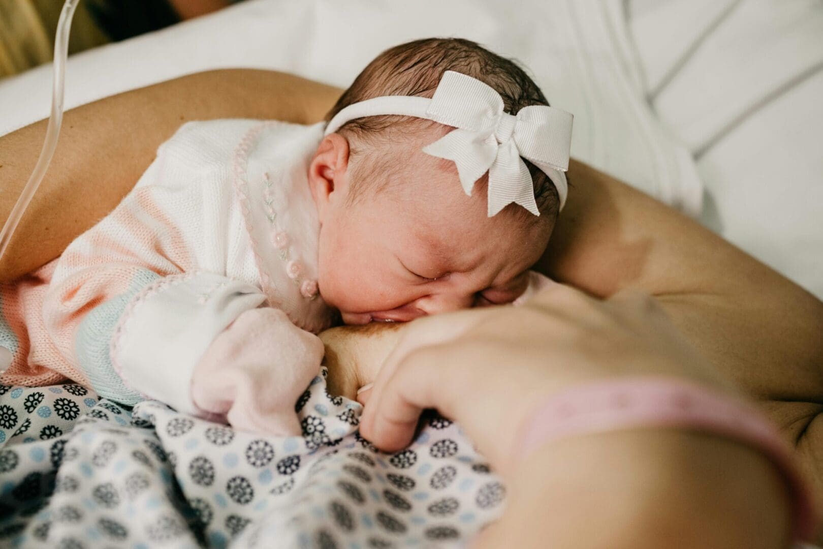 A baby is sleeping on the mother 's chest.